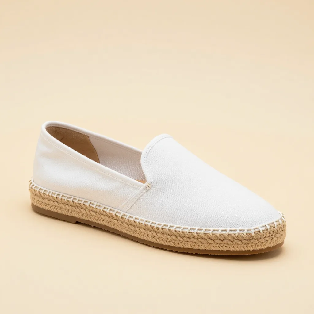 A classic white canvas espadrille on a light background